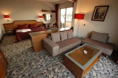 a living room with a couch and a bed at Hotel Hegsagone Marine Asia in Gebze