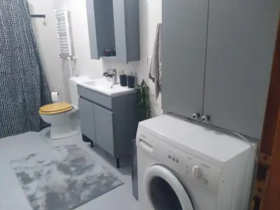 a bathroom with a washing machine and a sink at Apartament Ada in Buyukada