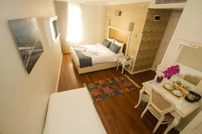 a small room with a bed and a table with a table at Venue Hotel Istanbul Old City in Istanbul