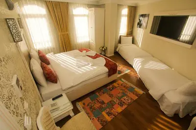 a small room with two beds and a television at Venue Hotel Istanbul Old City in Istanbul