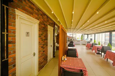 a restaurant with tables and chairs and a brick wall at Venue Hotel Istanbul Old City in Istanbul