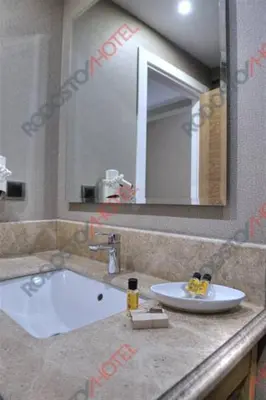 a bathroom with a sink and a bath tub at Rodosto Hotel in Tekirdag