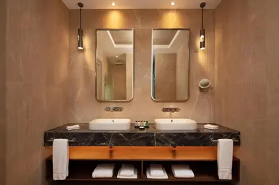 a bathroom with two sinks and a large mirror at Sheraton Istanbul Levent in Istanbul