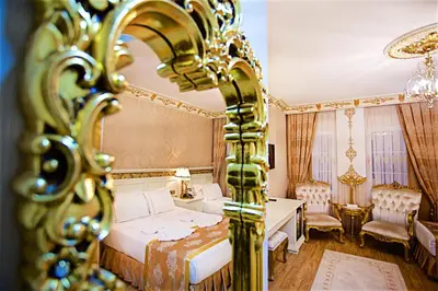 a bedroom with a bed and a mirror at White House Hotel Istanbul in Istanbul