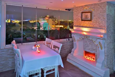 a table and a fireplace in a restaurant at White House Hotel Istanbul in Istanbul