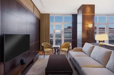 a living room with a couch and a flat screen tv at Park Hyatt Istanbul - Macka Palas in Istanbul