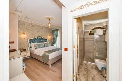 a bedroom with a king sized bed and a bathroom at Hotel 1453 in Istanbul