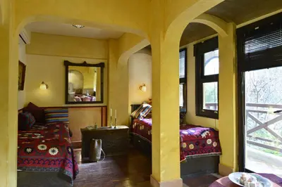 a room with two beds and a mirror at Hotel Empress Zoe in Istanbul