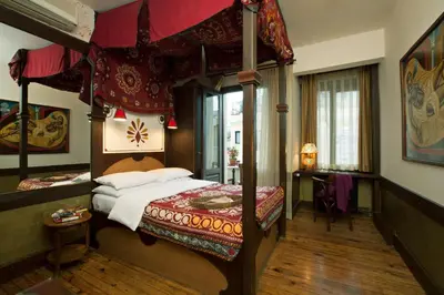 a bedroom with a canopy bed in a room at Hotel Empress Zoe in Istanbul