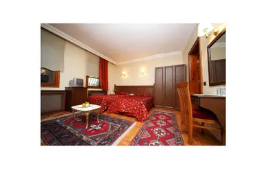a hotel room with a bed and a table at Turquhouse Hotel in Istanbul