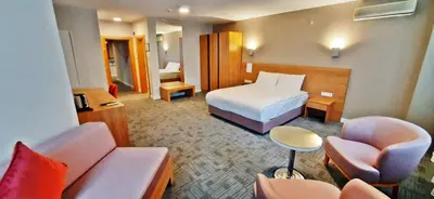 a hotel room with a bed and a couch at Silivri Park Hotel in Silivri