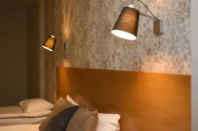 a bedroom with two lamps and a wooden headboard at Silivri Park Hotel in Silivri