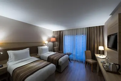a hotel room with two beds and a television at Regard Hotel in Istanbul