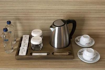 a coffee maker on a wooden tray on a table at Regard Hotel in Istanbul