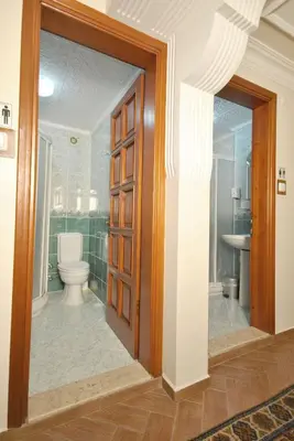 a bathroom with a toilet and a glass door at Side Hotel in Istanbul