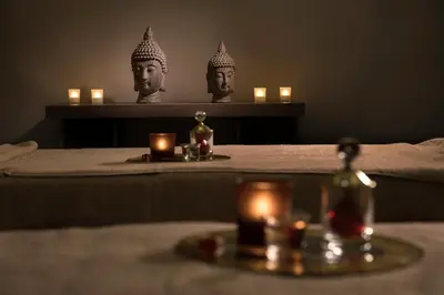 a room with two statues of heads on a bed with candles at Lionel Hotel Istanbul in Istanbul