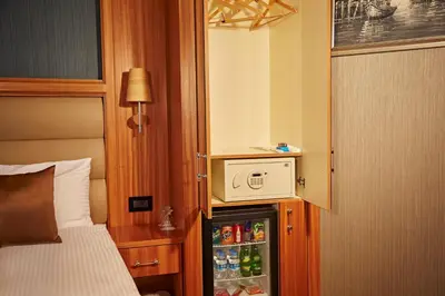 a small refrigerator in a hotel room with a microwave at Ilkbal Deluxe Hotel &Spa Istanbul in Istanbul