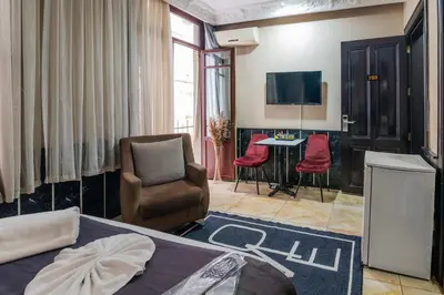 a hotel room with a bed and a table and chairs at Nest HOTEL Sisli in Istanbul