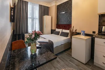 a hotel room with a bed and a table at Nest HOTEL Sisli in Istanbul