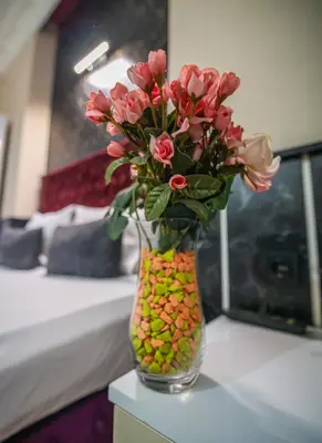 a vase filled with flowers sitting on a table at Nest HOTEL Sisli in Istanbul