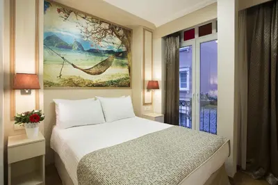 a bedroom with a bed and a painting on the wall at Hotel Evsen in Istanbul