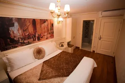 a bedroom with a large bed with a large painting on the wall at Hotel Evsen in Istanbul