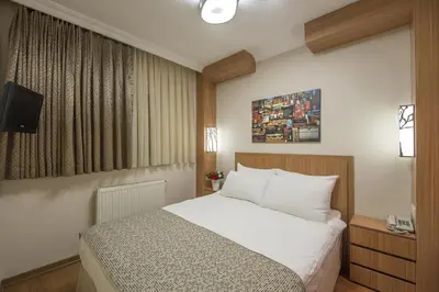 a hotel room with a bed and a television at Hotel Evsen in Istanbul