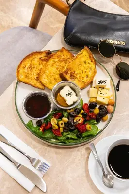 a plate of food with toast and a salad and cheese at Hotel Evsen in Istanbul