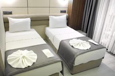 two beds in a hotel room with white pillows at AMARA OLD CITY HOTEL & Spa in Istanbul