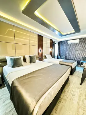 a hotel room with two beds and a couch at AMARA OLD CITY HOTEL & Spa in Istanbul