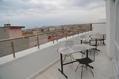a patio with tables and chairs on a balcony at Hotel Aksaray istanbul in Istanbul