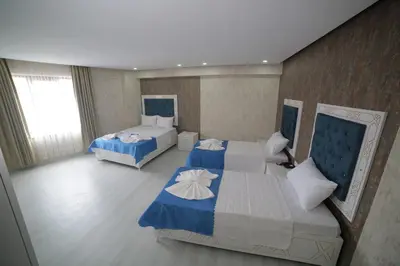 a bedroom with two beds with blue and white at Hotel Aksaray istanbul in Istanbul