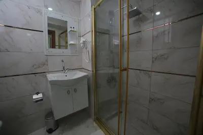 a bathroom with a shower and a sink and a mirror at Hotel Aksaray istanbul in Istanbul