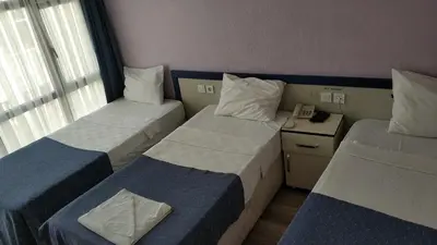 a hotel room with two beds and a telephone at Hotel Akkus in Istanbul