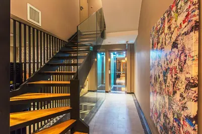 a staircase in a house with a painting on the wall at Redmont Hotel Nisantasi in Istanbul