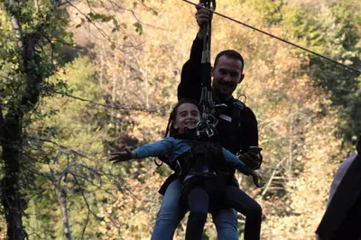 a man and a woman on a zip line at Karaaslan Kamping Tesisleri in Kazandere