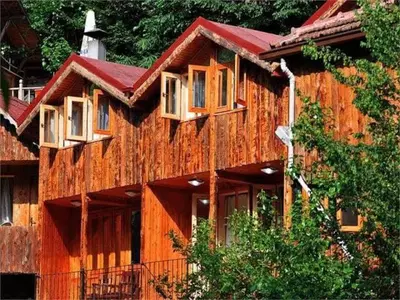 a wooden building with windows on the side of it at Karaaslan Kamping Tesisleri in Kazandere