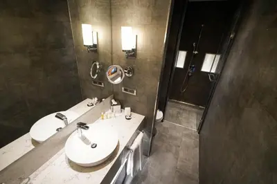 a bathroom with two sinks and a shower at Golden Tulip Istanbul Bayrampasa in Istanbul