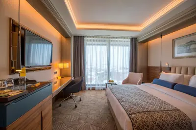 a hotel room with a bed and a desk at Golden Tulip Istanbul Bayrampasa in Istanbul