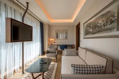 a living room with a couch and a tv at Golden Tulip Istanbul Bayrampasa in Istanbul