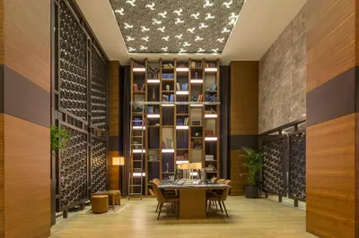 a dining room with a table and a wine cellar at Golden Tulip Istanbul Bayrampasa in Istanbul