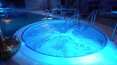 a jacuzzi tub with blue water in a room at İstanbul Medikal Termal in Tuzla