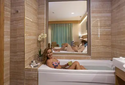 a woman sitting in a bath tub in a bathroom at İstanbul Medikal Termal in Tuzla