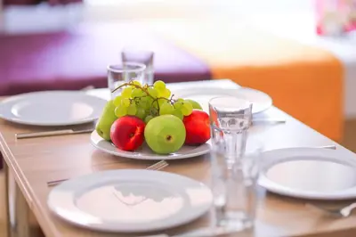 a table with a plate of fruit on it at Palmada Hotel in Sakarya