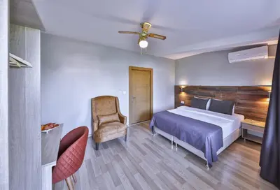 a hotel room with a bed and a chair at Palmada Hotel in Sakarya