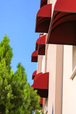 a building with red balconies on the side of it at Palmada Hotel in Sakarya