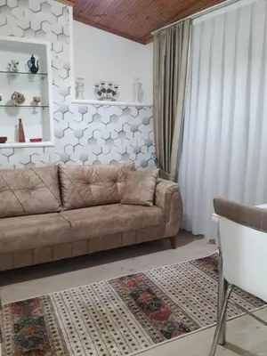 a living room with a brown couch and a white wall at Golden Life Apart Hotel in Istanbul