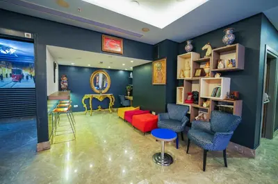 a living room with a red couch and chairs at Trip Bosphorus Taksim Hotel in Istanbul