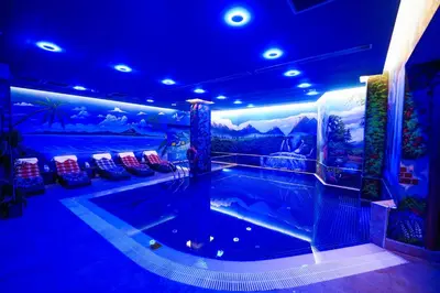 a large swimming pool in a room with a blue ceiling at Trip Bosphorus Taksim Hotel in Istanbul