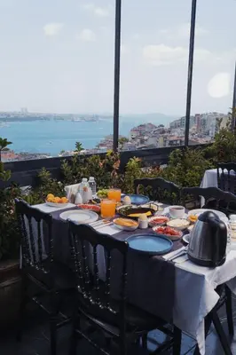 a table with food and a view of the ocean at Trip Bosphorus Taksim Hotel in Istanbul